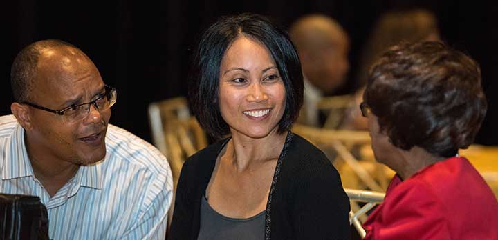 Three audience members chat at a Multicultural Awareness Council event
