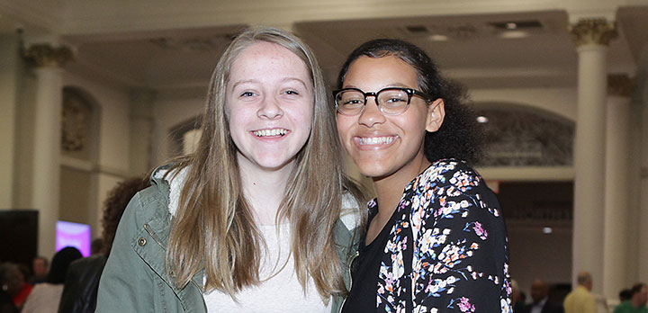 Two college students posing for a photo in Music Hall